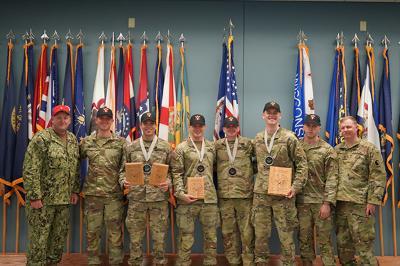 VMI cadets receive award plaques at an Army ROTC pistol competition.