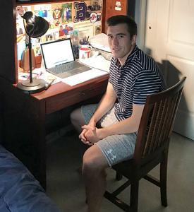 Thomas Muldowney '21 is shown in front of his laptop computer. 