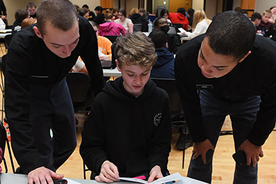 VMI students, known as cadets, work with an area middle school math student as part of a problem-solving program at a military college in Virginia.