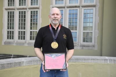 Col. Dan Barr 鈥�74 displays his awards from the United States Powerlifting Coalition.